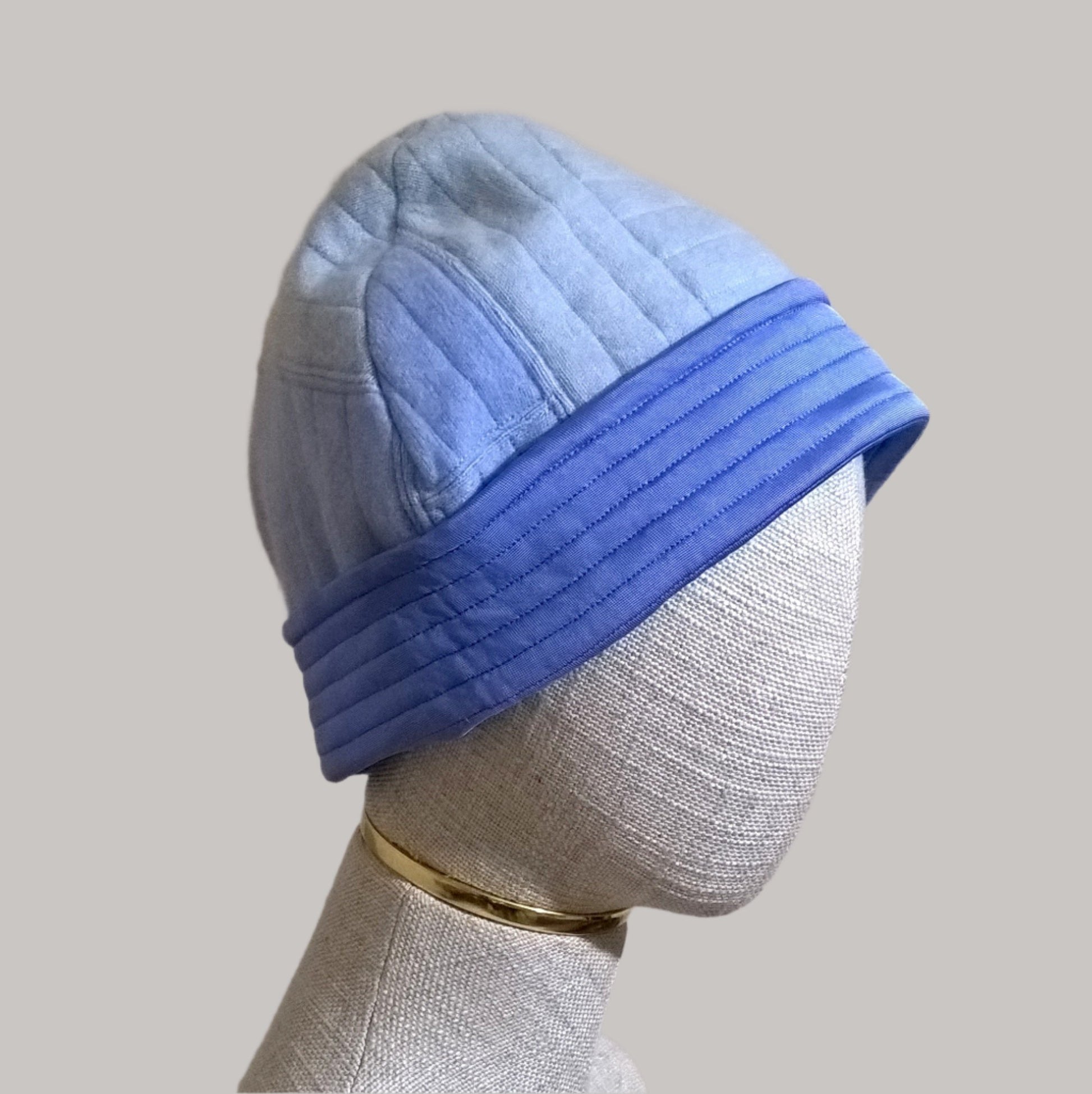 Side view of up-cycled cashmere beanie hat in shades of blue