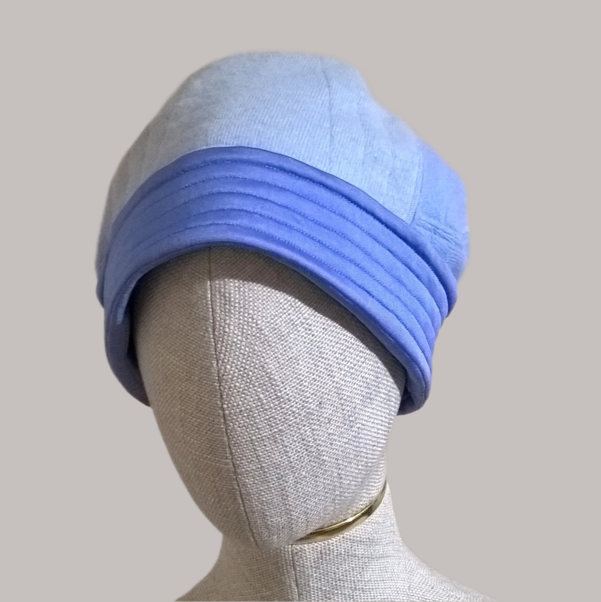 Blue patchwork beanie hat handmade from up-cycled cashmere  sweaters  quilted and lined with pure silk jersey , which is stitched to form a luxurious silk cuff to the hat