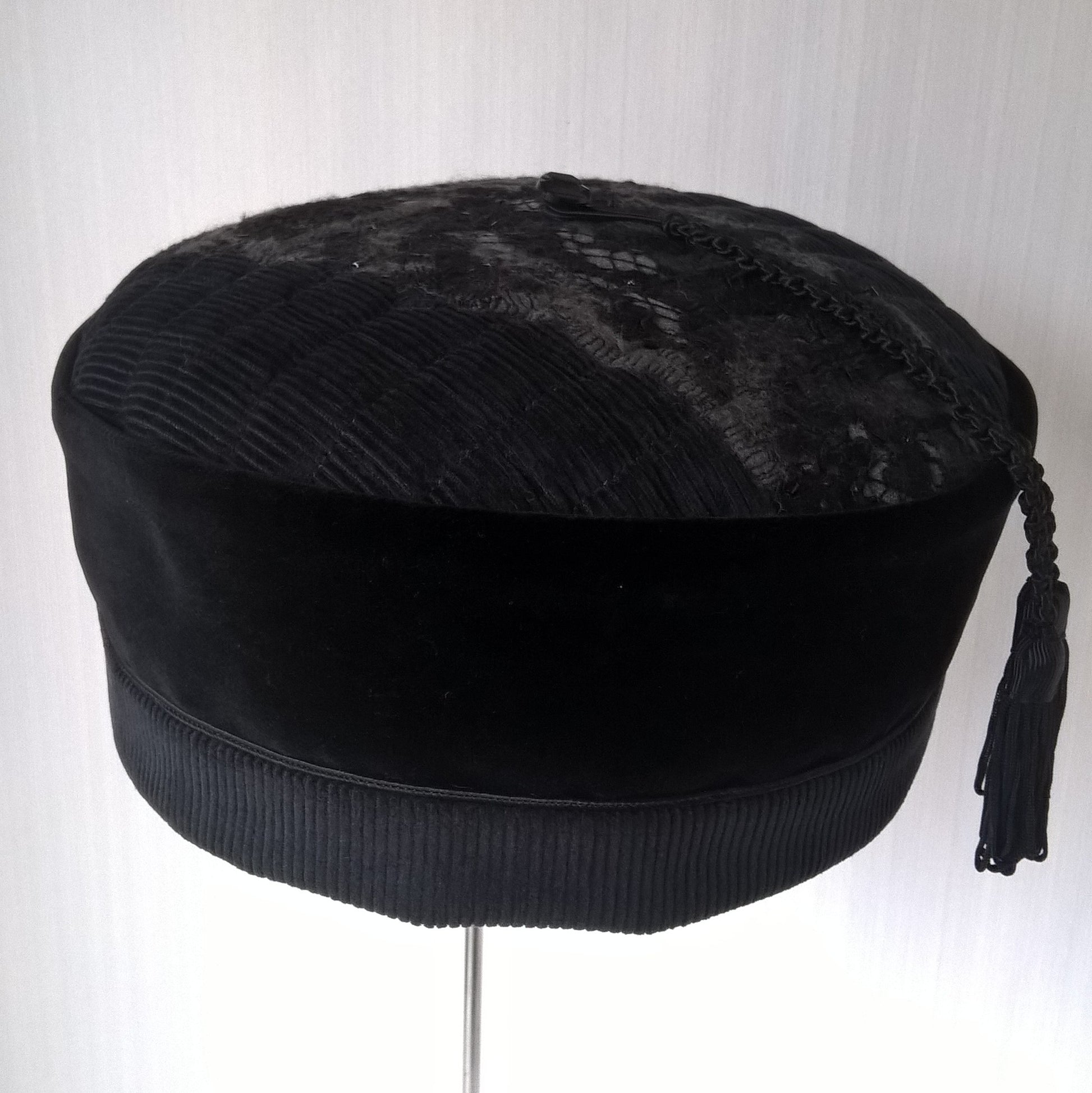 Black velvet pillbox shaped hat with nuno felted corduroy tip and macrame satin tassel