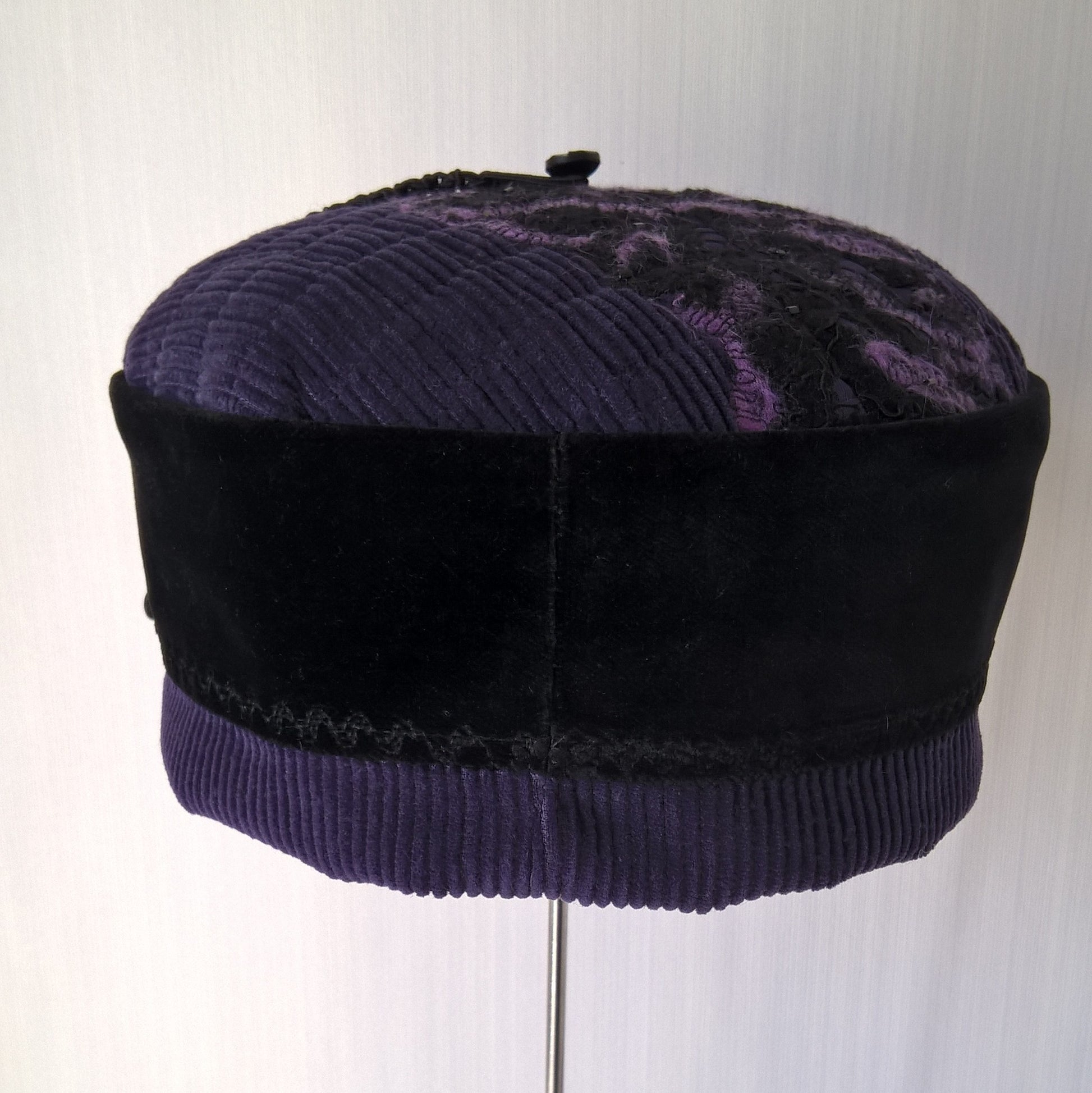 Back view of purple and black smoking cap