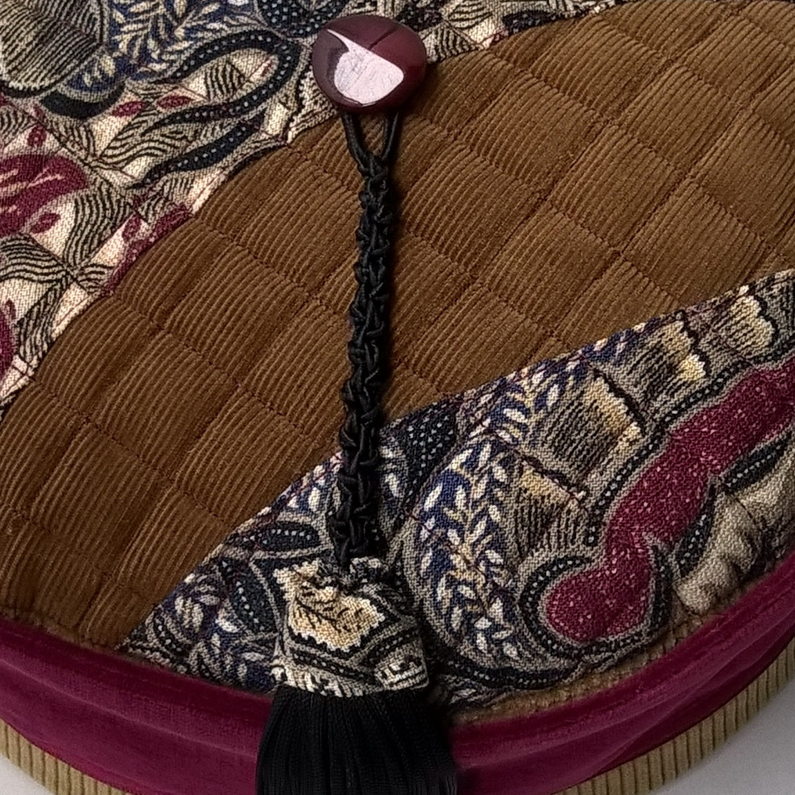 Velvet smoking cap has a removable macrame and paisley tassel