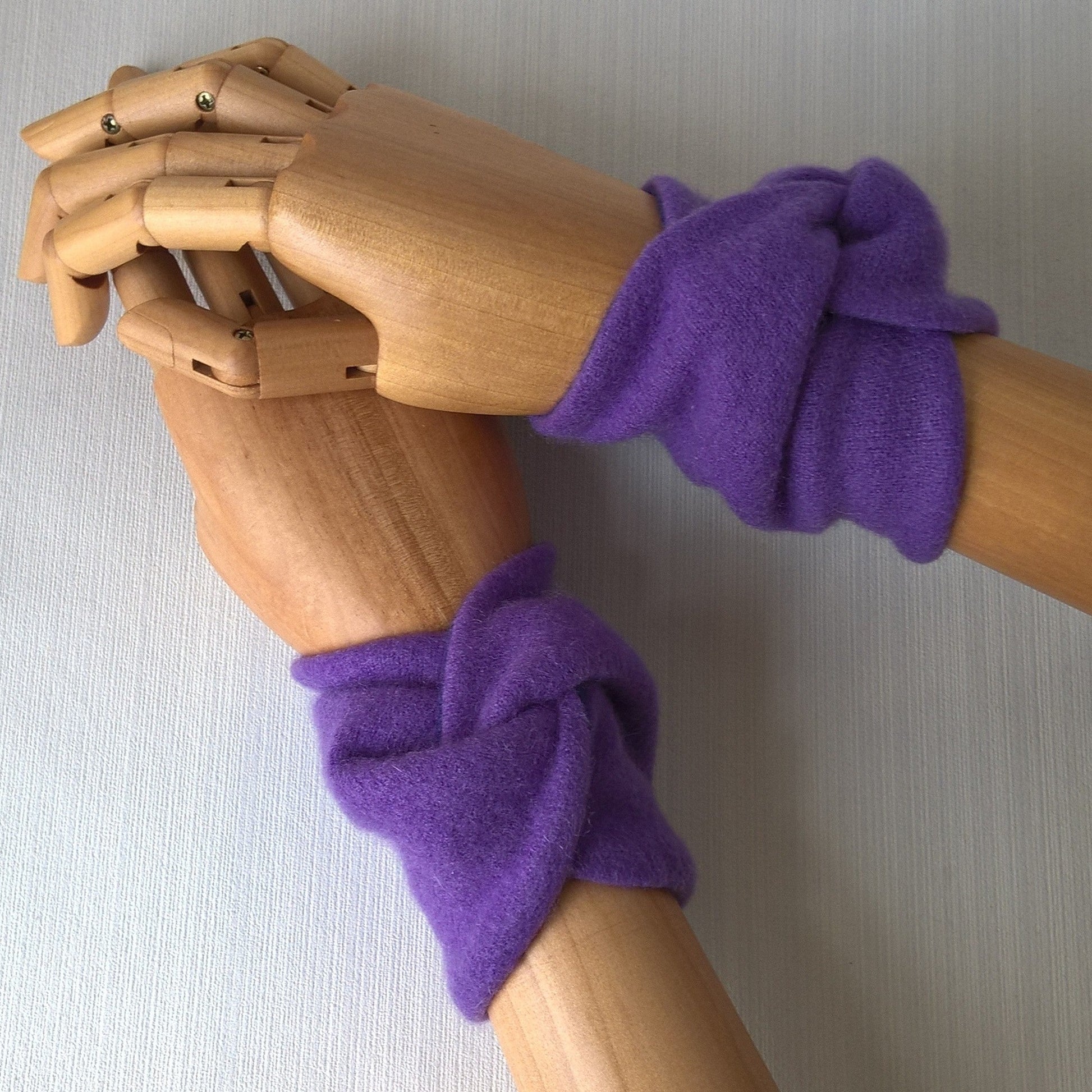 A pair of violet coloured felted cashmere wrist warmers
