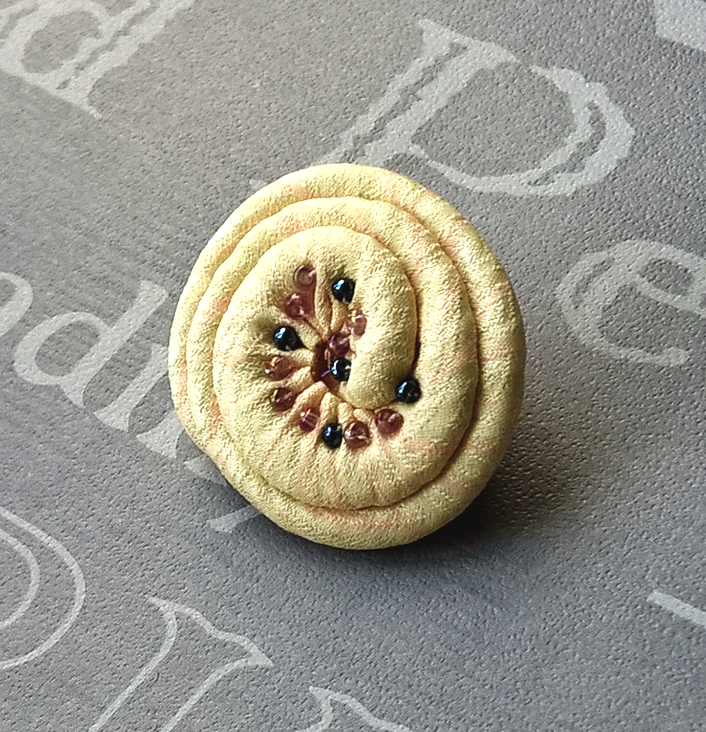 Lemon Japanese silk lapel pin in a shell design with beading