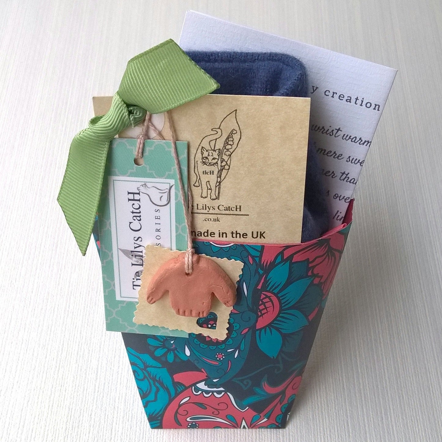 The wrist warmers are gift wrapped in a patterned or plain traditional origami festival cup