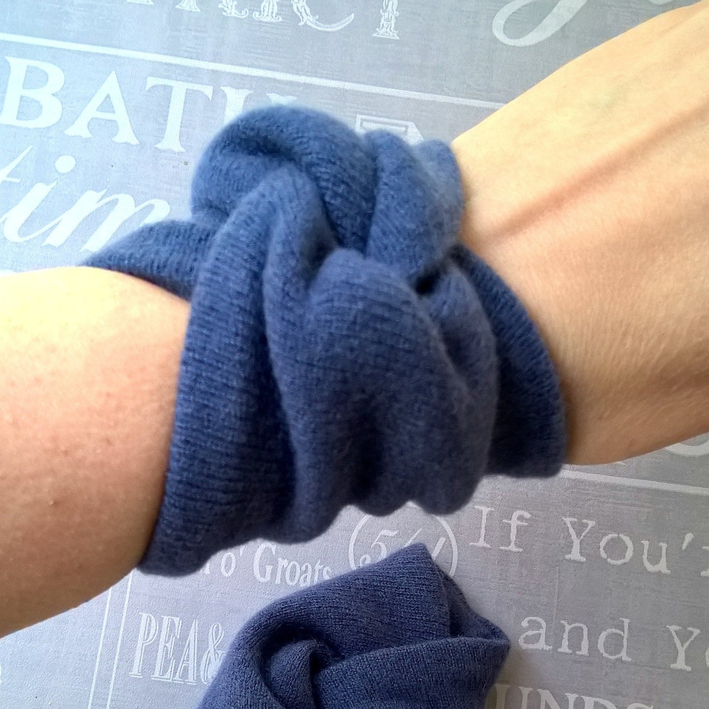 Spruce blue pure cashmere wrist warmers being worn