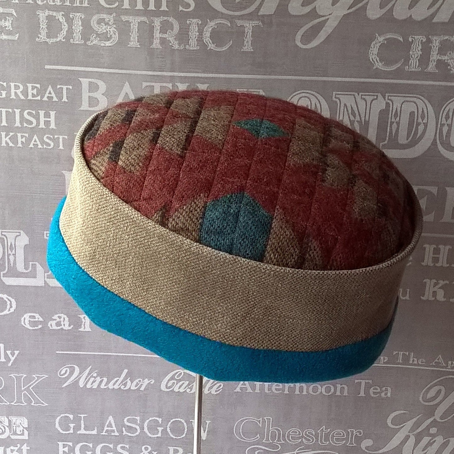 Multi coloured quilted fleece hat with an Aztec design by TwiLd Capit Hog