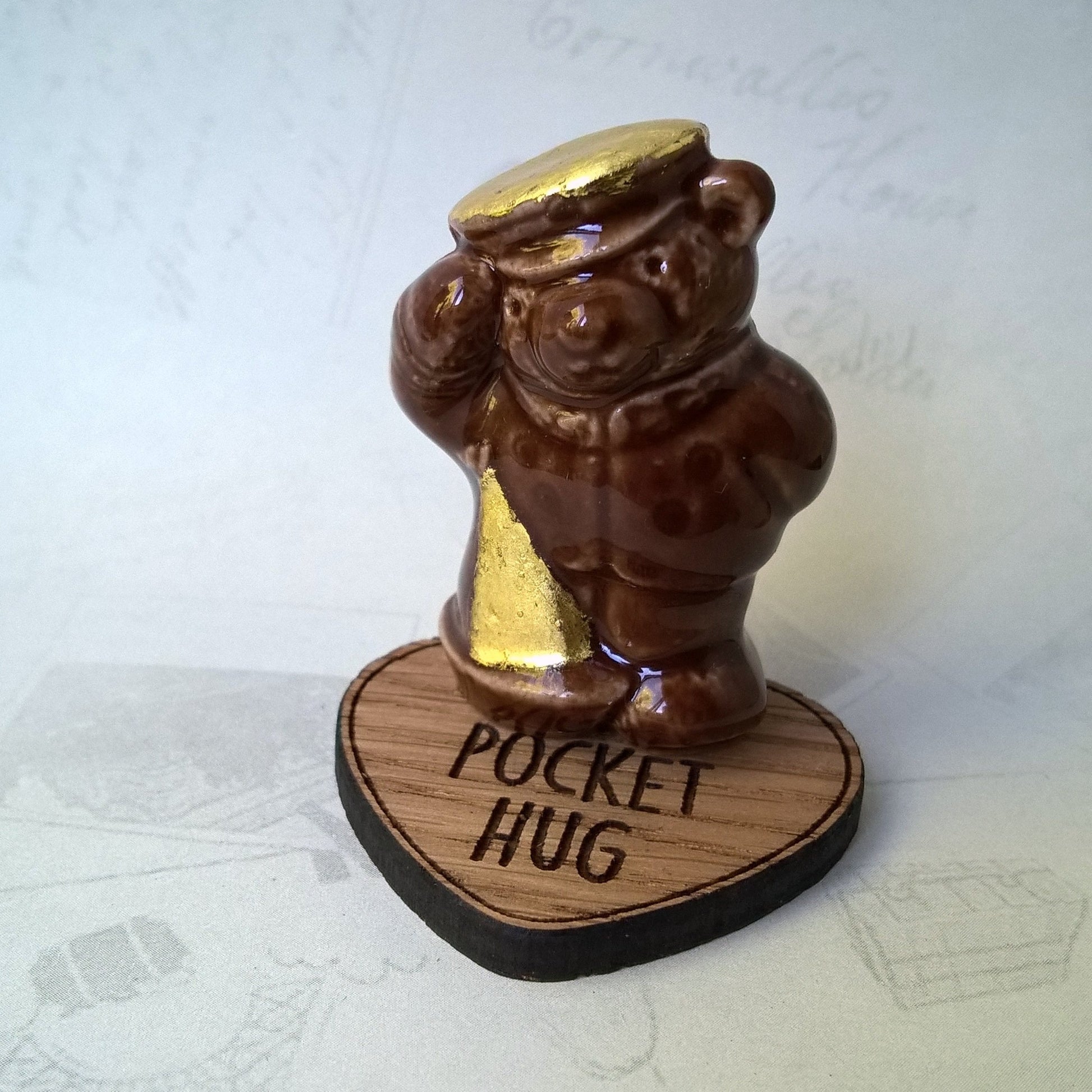 The wooden heart pocket hug can be used as a stand and surface protector for the little ceramic bears