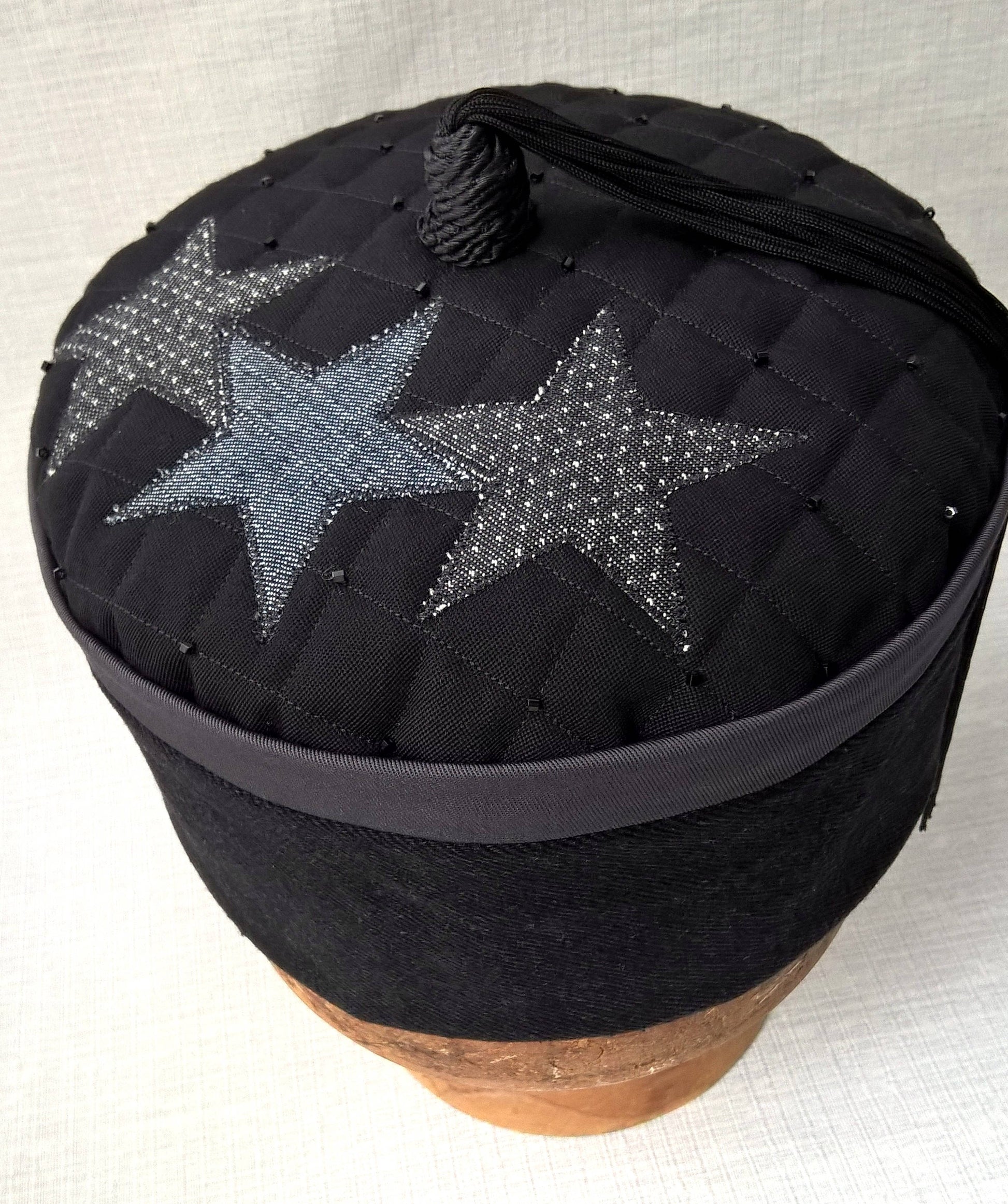 The smoking cap has a uniquely quilted and beaded tip with applique denim stars