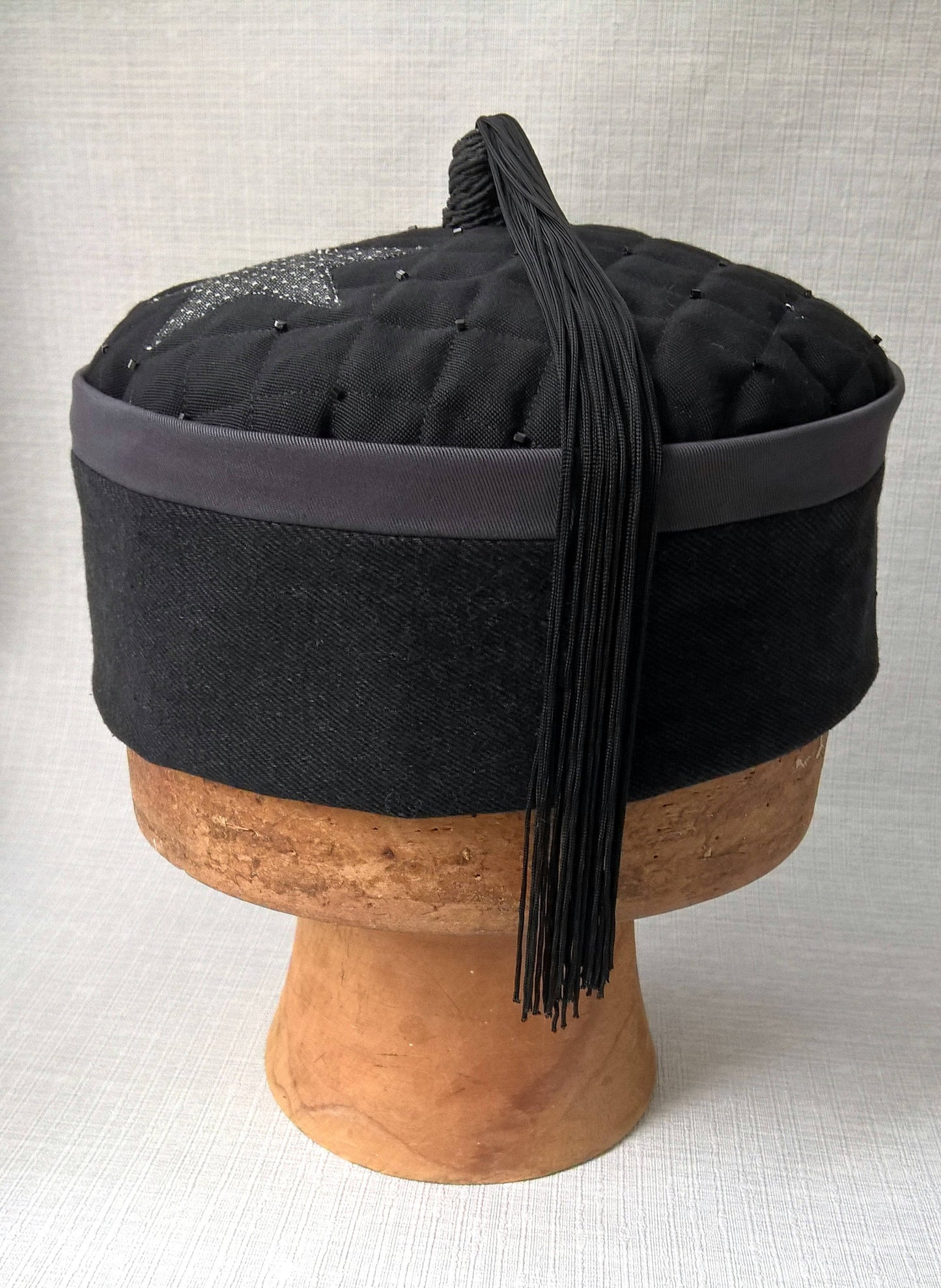 A beautiful tassel crafted from vintage black fringing completes this mens smoking cap