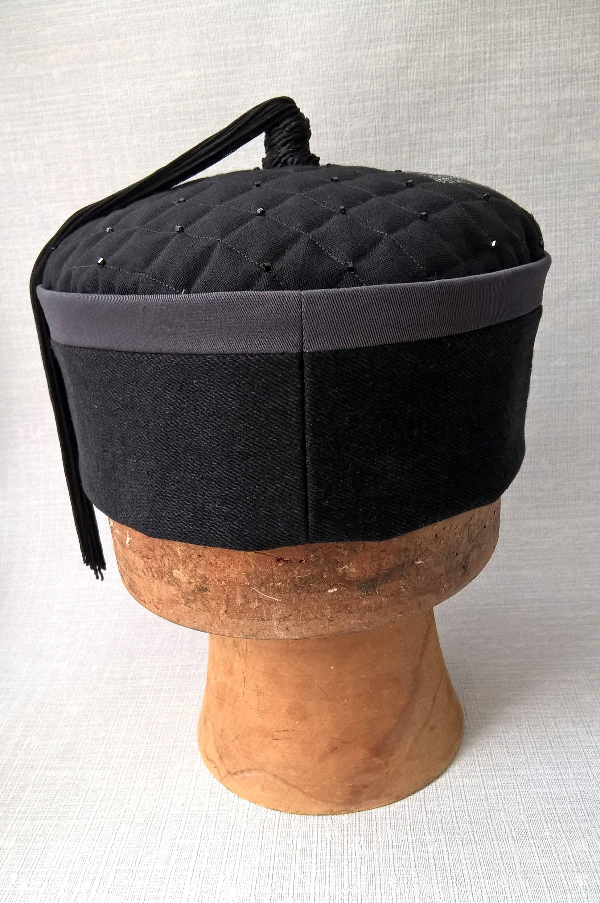 Back view of the wizards tassel smoking cap in black and grey with applique stars