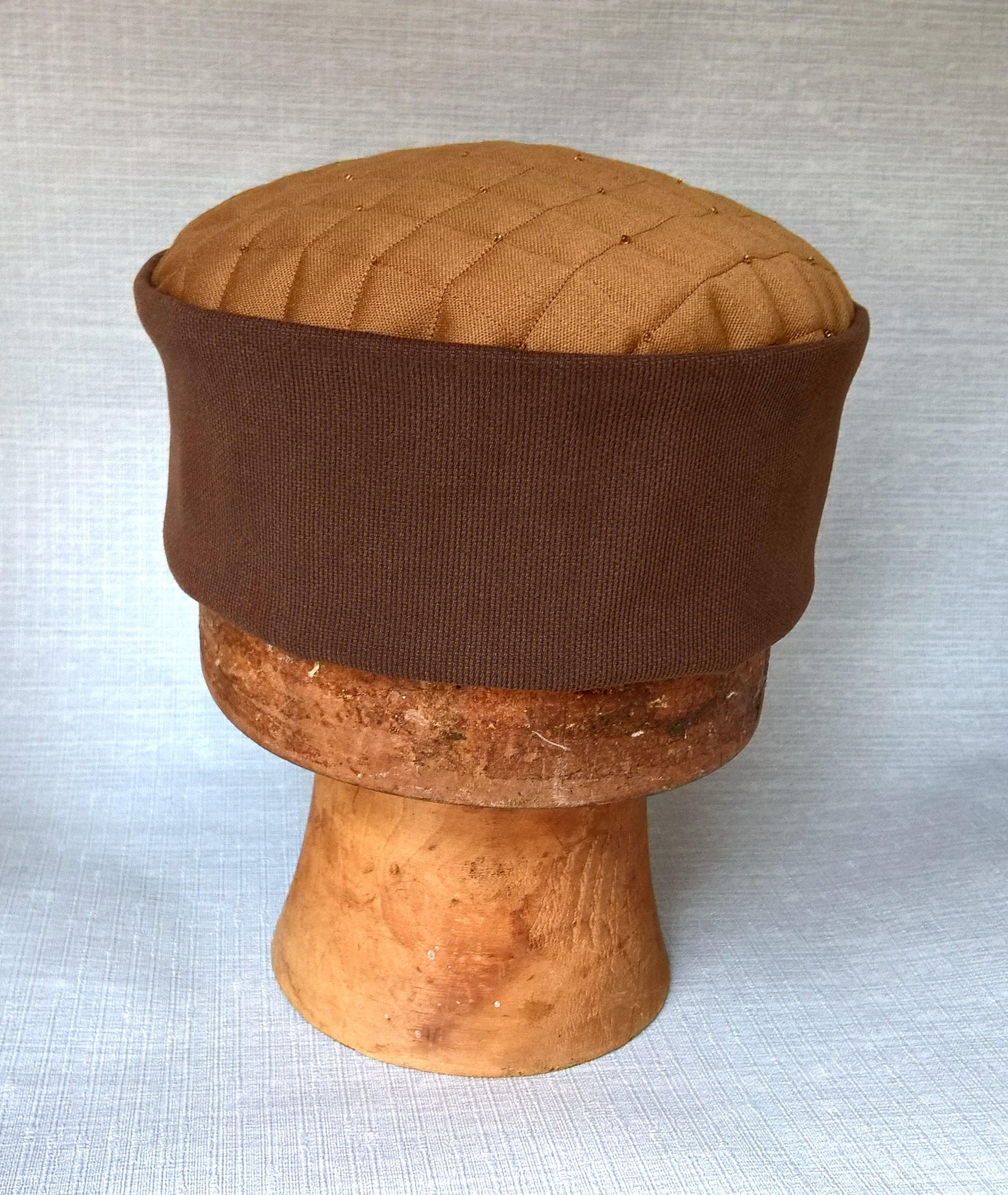 A pillbox shaped kufi hat handmade with quilted tip 