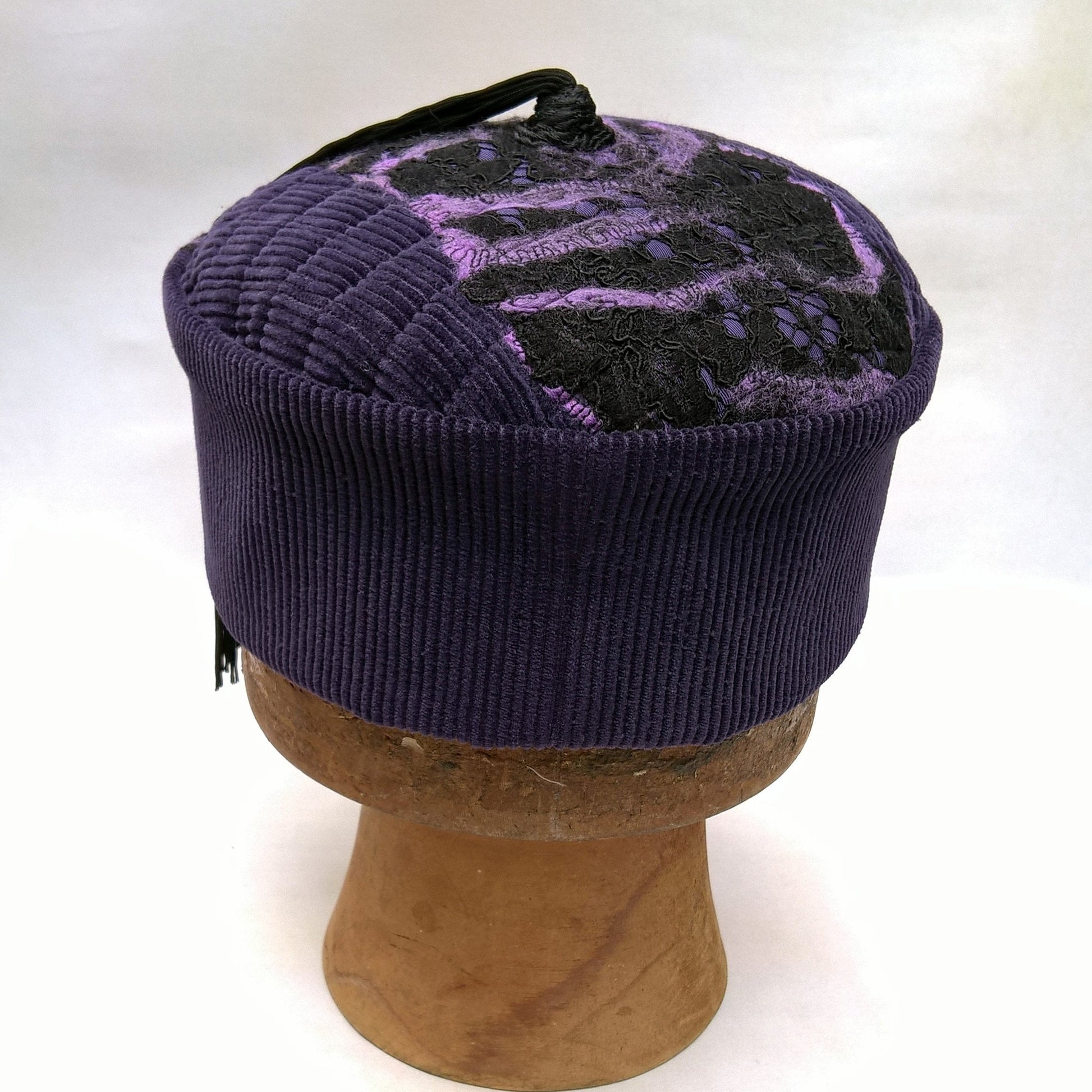 Back of purple smoking cap with nuno felting and black tassel